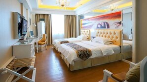 A hotel room with a large bed, a desk, a chair, a TV, and a painting on the wall. - Junfu Hotel (Guangzhou Panyu Square Metro Station) (Guangzhou)