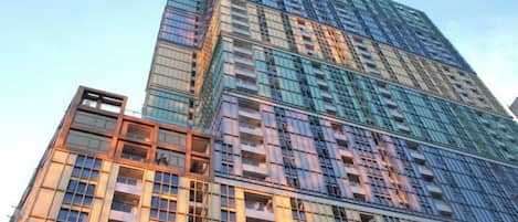 A multi-story building with a modern architectural design, featuring numerous windows and balconies.