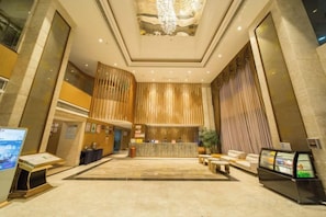 A spacious lobby with a reception desk, seating area, and a large chandelier. - GanZhouXiangjiangwan International Hotel (South Gate Ancient City Wall) (Ganzhou)