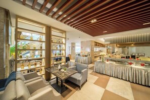 A hotel lobby with seating, a reception desk, and a display of items.