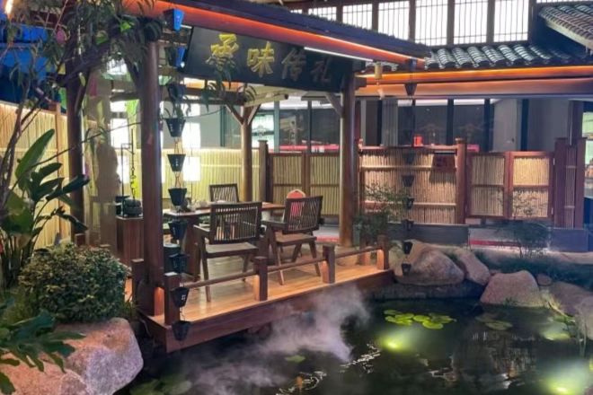 A traditional Japanese-style restaurant with a wooden deck overlooking a koi pond.