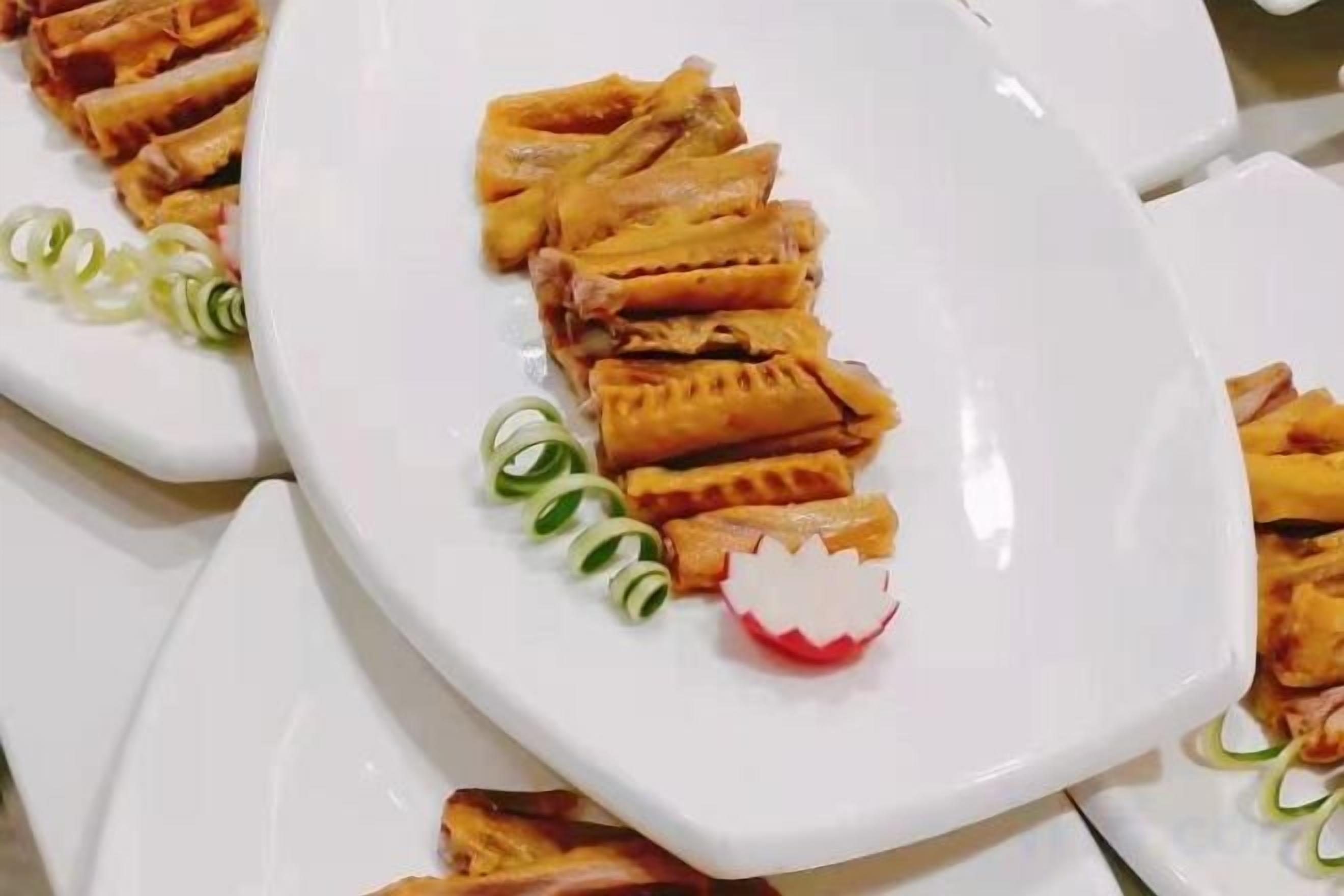 A white plate with food items, possibly a dessert, arranged on a table.