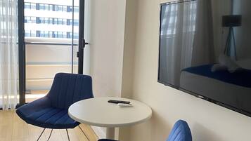 Deluxe Studio, Balcony, Sea View | Living area | TV