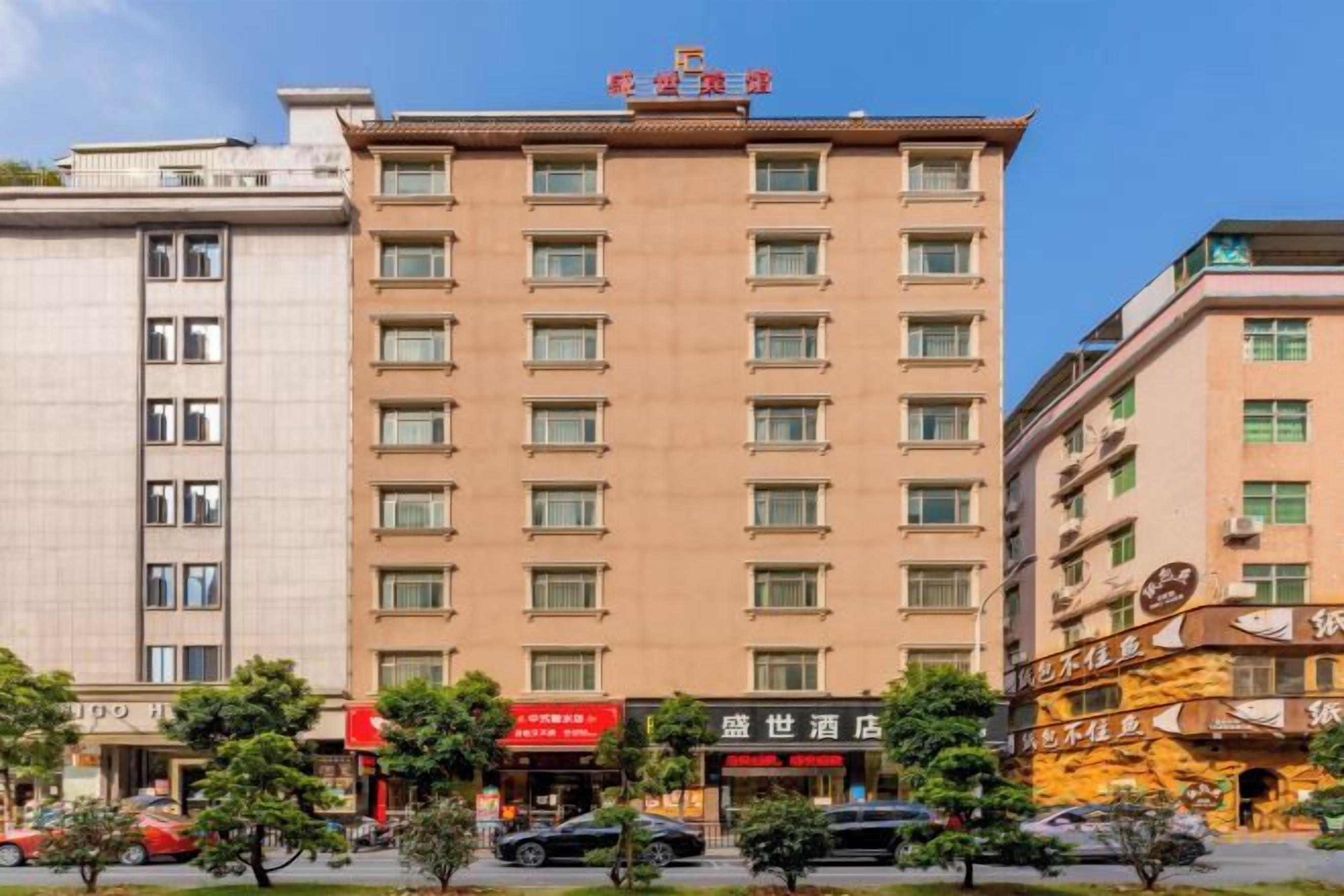 A multi-story hotel with a flat facade, several windows per floor, and a sign indicating a hotel name.