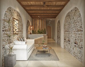 A spacious hallway with a white sofa, a round coffee table, and a cactus plant. - Lakeview Residence (Hanoi)