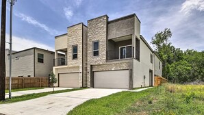 A modern two-story house with a garage, a stone facade, and a small front yard. - 3BD Houston Home: Fenced Yard & Minutes to Downtown Houston (Houston)