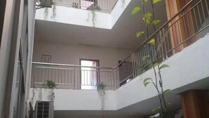 A multi-level building with balconies, railings, and windows. - Jingxi Guoyu Convenience Hotel (Jingxi)