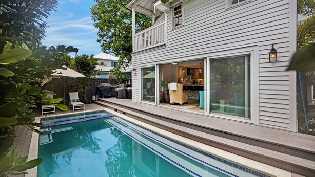 A two-story house with a swimming pool, a covered patio, and a dining area visible through large sliding glass doors. - **SOUTHERN STAR @ THE MEADOWS** Home & Pool + Last Key White Glove Service... (Key West)