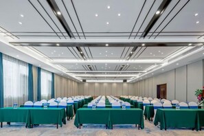 A conference room with long tables, chairs, and a podium. - Kameidun Hotel (Changsha University of Science and Technology Yuntang Campus) (Changsha)