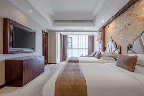 A hotel room with a large bed, a TV, a wooden cabinet, and a view of the outdoors.