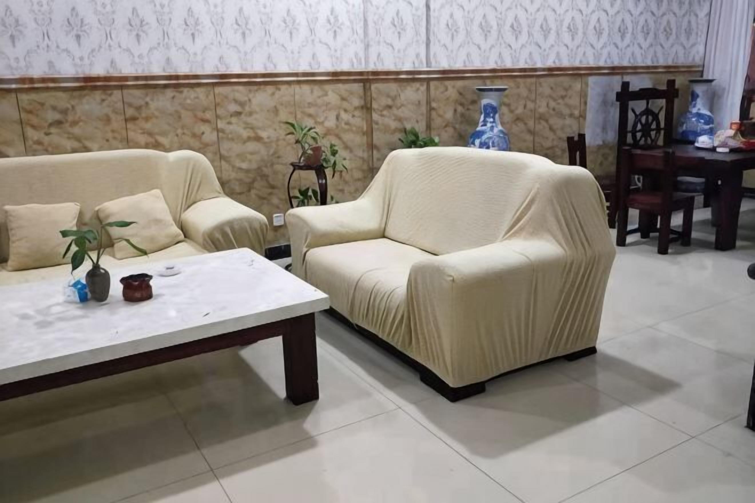 A living room with a beige sofa, a coffee table, and decorative items.
