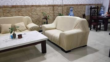 A living room with a beige sofa, a coffee table, and decorative items.