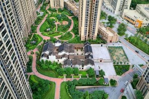 A high-rise residential building with a central courtyard, surrounded by greenery and a winding path. - Guangzhou Feifan Apartment (Guangzhou)