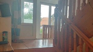 A wooden staircase with a handrail leading to a landing. - Budget Rooms (Sarajevo)