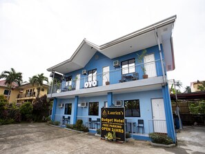 A two-story building with a sign for 'Laurien's Budget Hotel' offering free parking and 24-hour access. - Lauriens Hotel Tagaytay (Tagaytay)