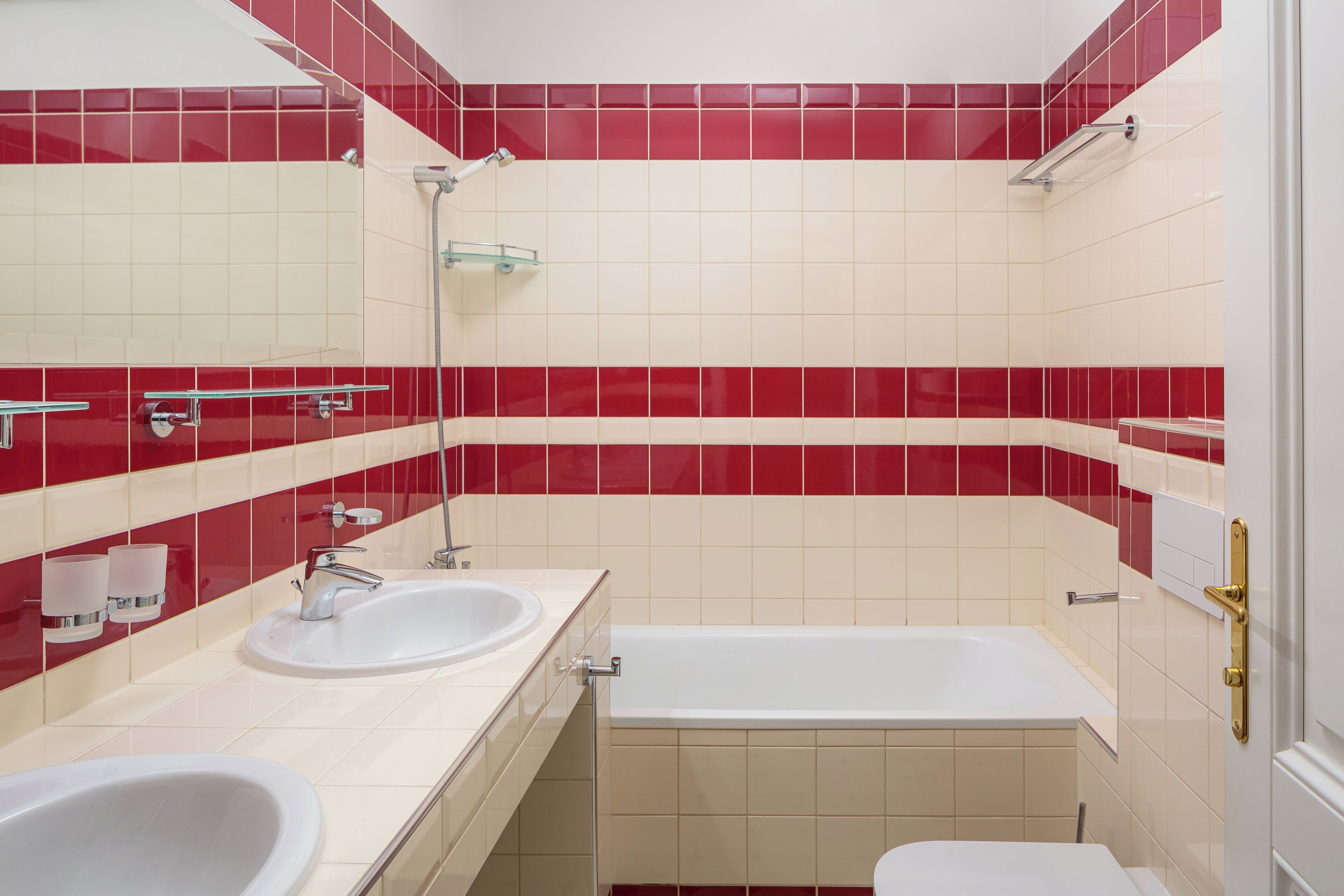 A bathroom with two sinks, a bathtub, and a shower.