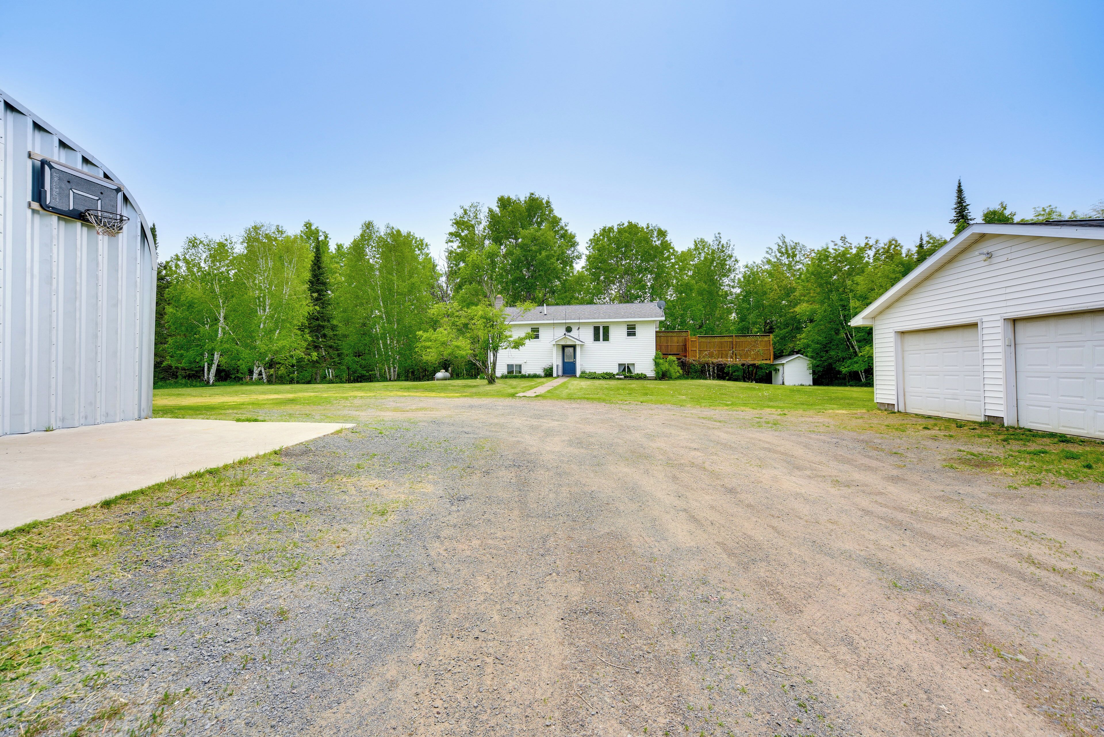 A residential area with a house, a garage, and a shed.