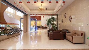A spacious lobby with a chandelier, seating area, and a bike parking area. - Mingdu Hoki International Hotel (Changzhou)