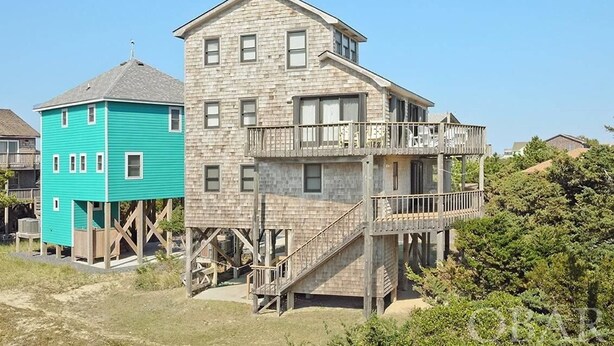 A two-story house with a balcony on the upper floor. -  Hatteras House  (Hatteras)