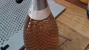 A kitchen with a bottle of honey on a wooden countertop.