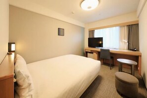 A hotel room with a bed, a desk with a chair, a television, and a small table. - Richmond Hotel Higashi Osaka (Higashiosaka)