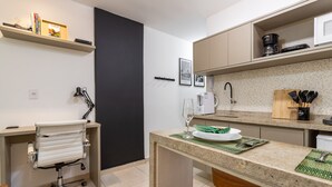 A modern kitchen with a countertop, a sink, and a chair. - In front of the underground and 8 minutes from the beach | SF228 (Rio de Janeiro)