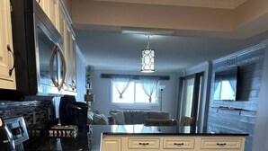 A modern kitchen with a central island, built-in appliances, and a large window providing natural light. - 3 bedroom condo on the 12th floor in beautiful Panama City Beach (Panama City Beach)