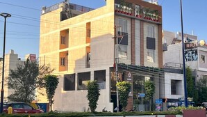 A multi-story building with a modern design, featuring balconies and large windows. - Wishotel Inn Skymoon  (Indore)