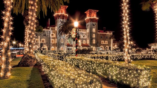 A historic building with two towers, surrounded by a well-lit garden with trees and pathways. - Spacious Home Walk to Historic DT w/Yard, Bikes (Saint Augustine)