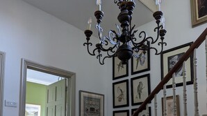 A staircase with white balusters and a dark wooden handrail, leading to a room with green walls and a door. - 17 Trent Road  (London)