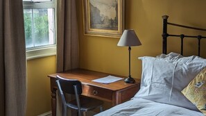 A room with a bed, a desk, and a chair. There is a lamp on the desk. - 17 Trent Road  (London)