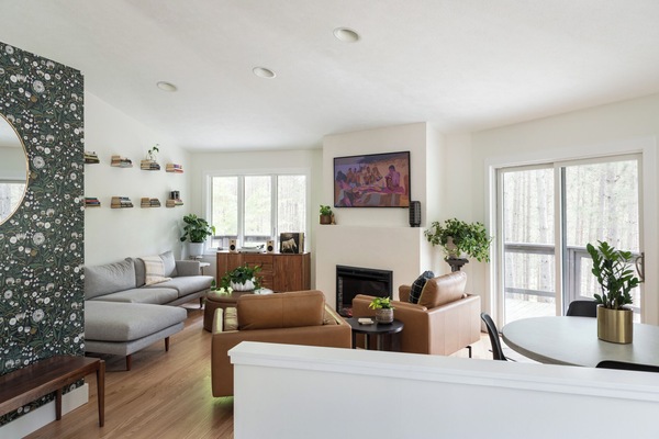 Large living space on second floor with smaller dining table.