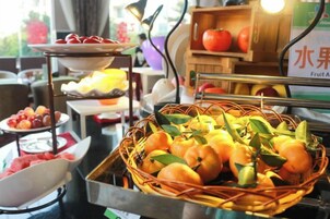 Un bufé con diversas frutas y un puesto de frutas.