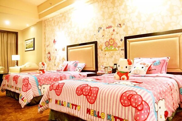 A hotel room with two beds, each adorned with Hello Kitty-themed bedding.