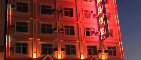 A multi-story hotel building with a prominent sign.