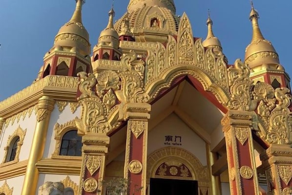 A building with ornate architectural details, including multiple domes and intricate carvings. - Mangshi Cuidi Hotel (Mangshi)