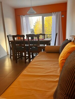 Enjoy meals in the dining area with a wooden table and comfortable seating for four.