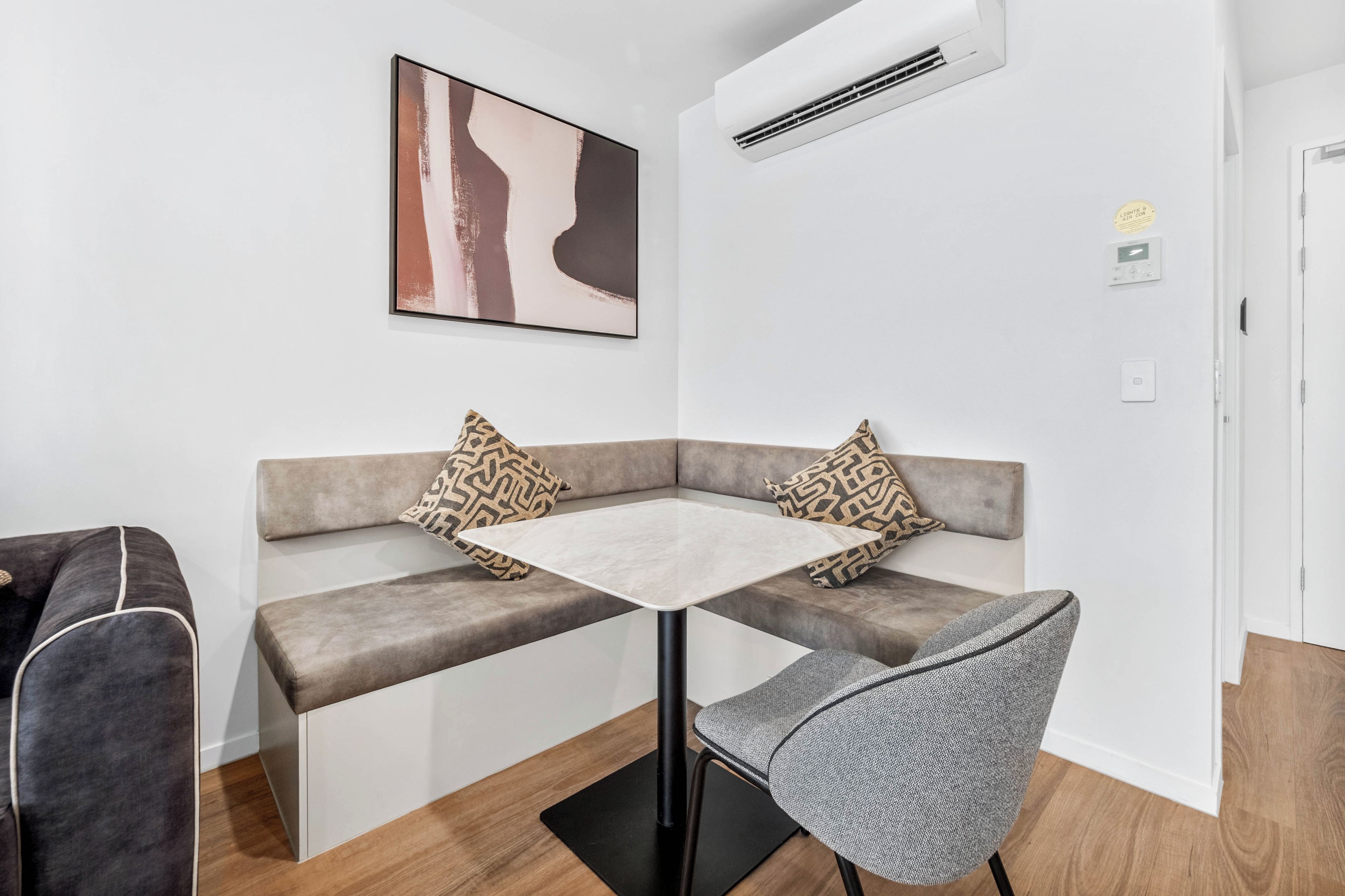 A modern room with a sofa, a small table, and a chair.
