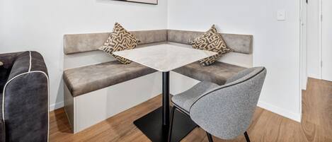 A modern room with a sofa, a small table, and a chair.