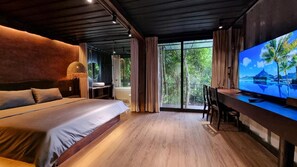 A modern bedroom with a large bed, a desk, and a television. - YesHue Eco Waterfall Retreat (Hue)