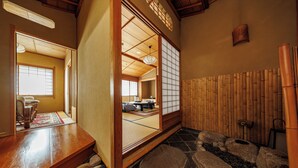 A traditional Japanese room with tatami flooring, a shoji screen, and a wooden interior. - Shikitei (Nara)