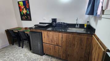 Fridge, microwave, coffee/tea maker, cookware/dishes/utensils