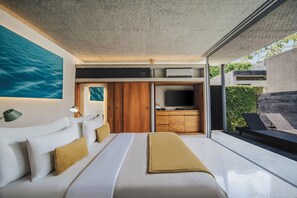 A modern bedroom with a large bed, a TV, and a view of the outdoors.