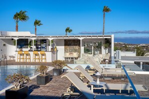A rooftop pool area with lounge chairs, a bar, and a view of the ocean. - Casa Serena 10, Suite  8 • Breakfast included (+18) (Macher)
