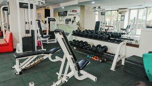 A gym with various exercise equipment, including dumbbells and weight machines.