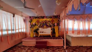 A room with a stage, curtains, and a patterned carpet.