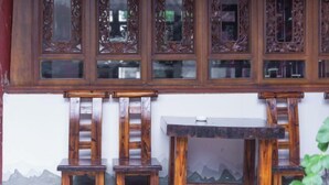 A traditional wooden room with a sloped ceiling and a decorative wooden panel above the door. - Yahve Academy Hotel (Dali City)