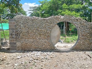A stone wall with a circular opening.