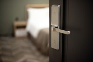 A hotel room door with a modern handle and a visible light switch. - Estetico Boutique Hotel (Yerevan)