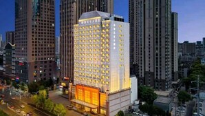 A high-rise hotel with a modern design, featuring a prominent entrance and multiple floors.